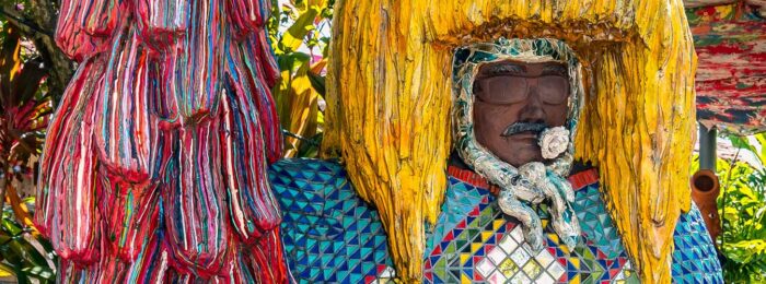 Photo of carved human figure with large yellow headdress in Brazil