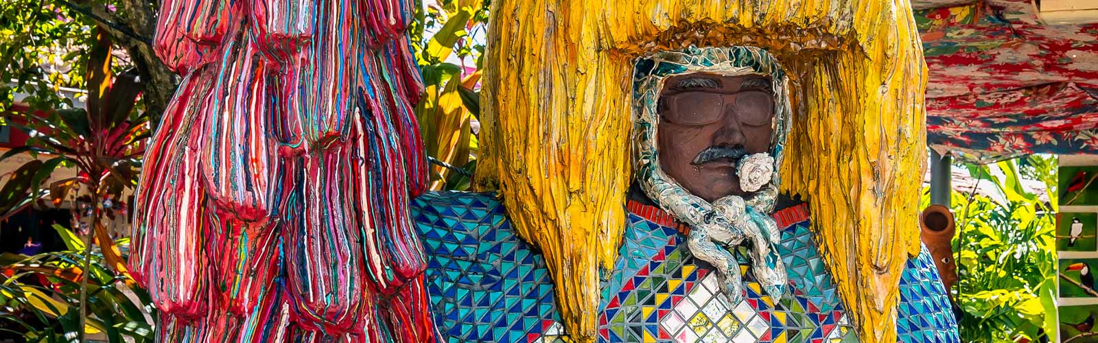 Photo of carved human figure with large yellow headdress in Brazil