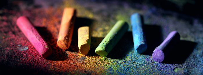 colorful-pieces-of-chalk-against-black-background