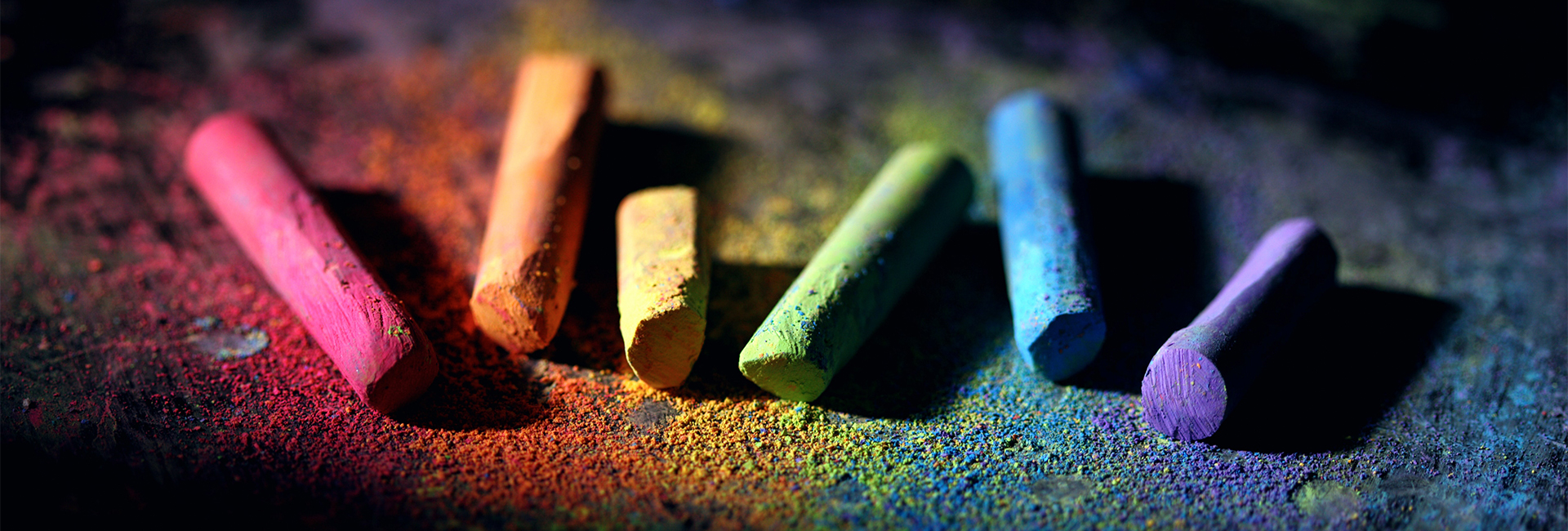 colorful-pieces-of-chalk-against-black-background