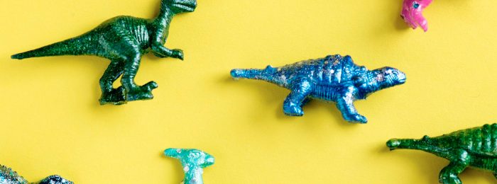 toy-dinosaurs-yellow-background