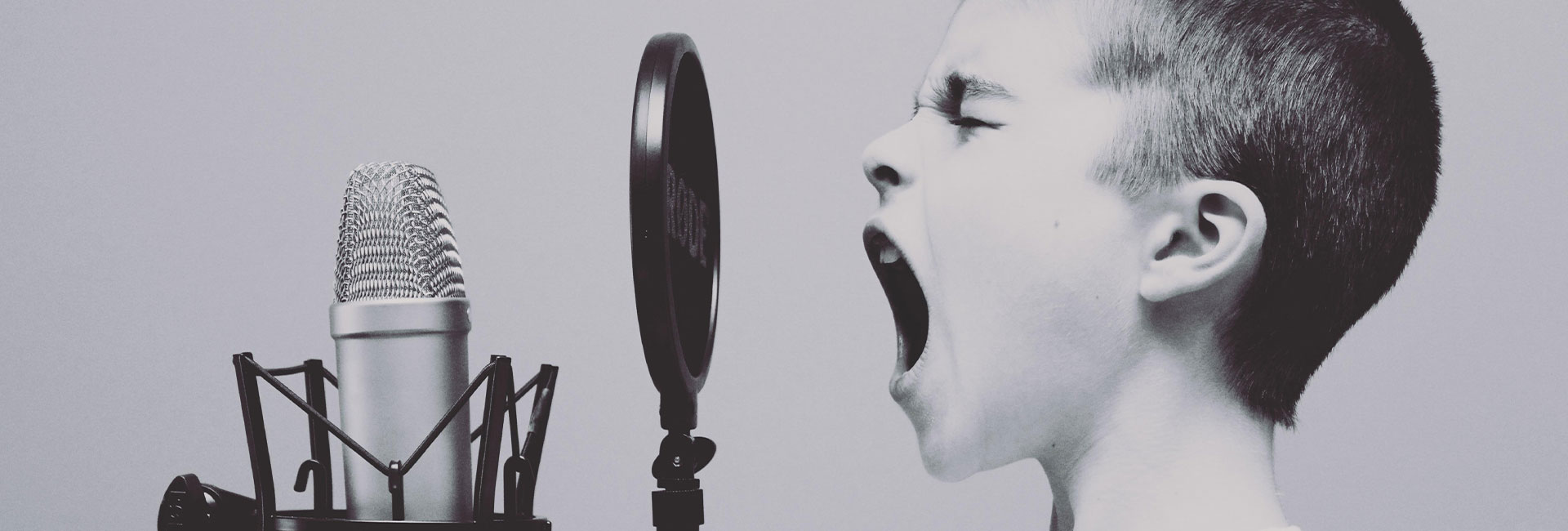 boy-shouting-into-microphone
