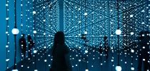 Silhouette of woman standing in front of blue lights photo