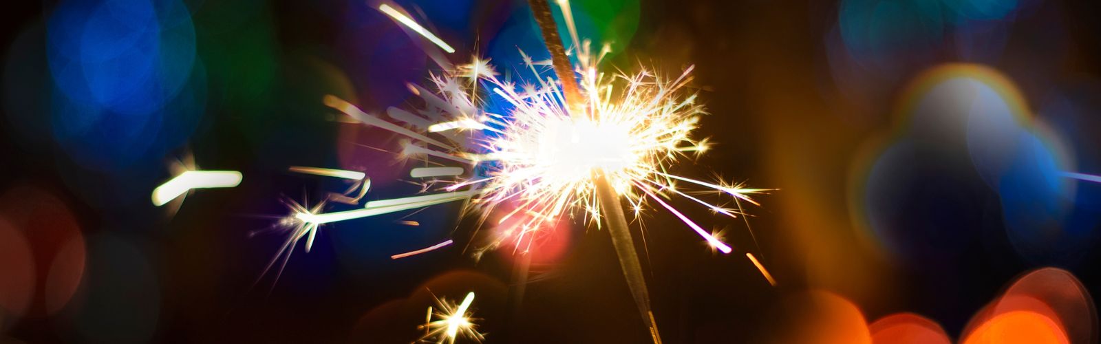 Hand Holding a Burning Sparkler Firework, Happy New Year and Merry Christmas Concept