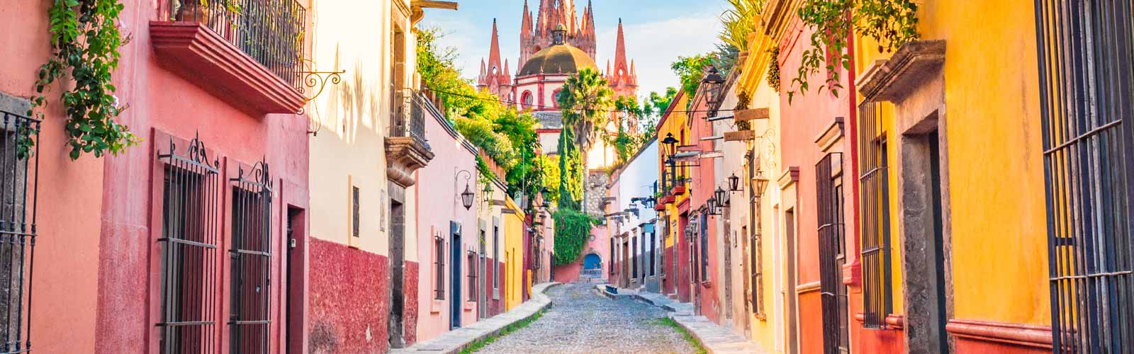 Vibrant, colorful buildings line a street in Mexico