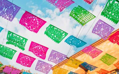 Colorful flags below a bright sky in Mexico