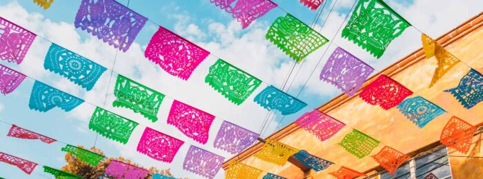 Colorful flags below a bright sky in Mexico