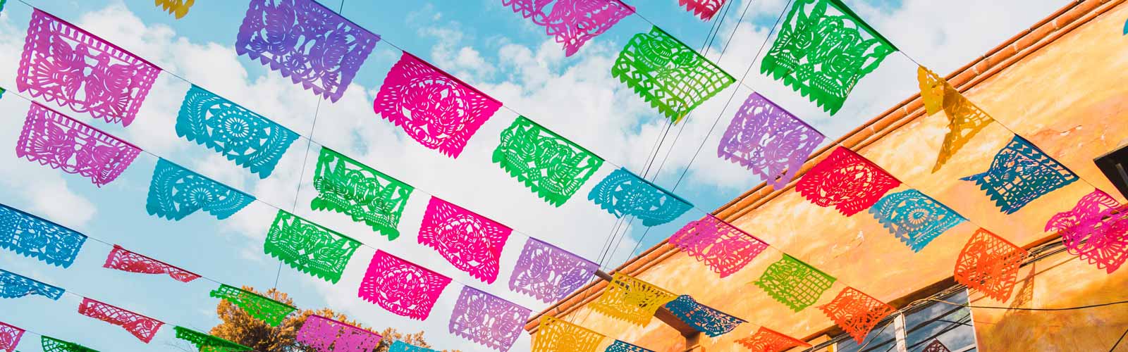 Colorful flags below a bright sky in Mexico