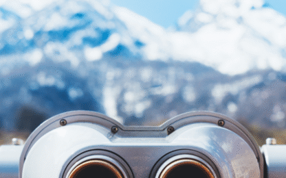 touristic telescope look at the city with view snow mountains
