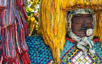 Photo of carved human figure with large yellow headdress in Brazil