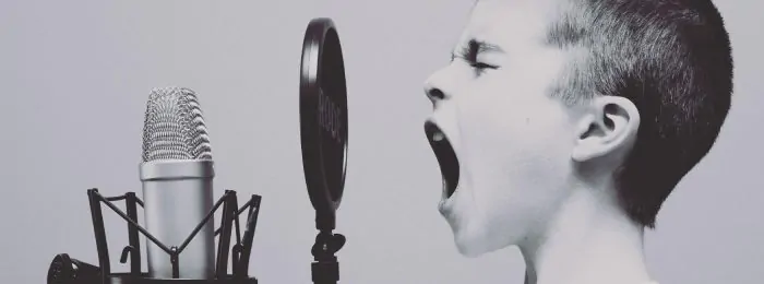 boy-shouting-into-microphone