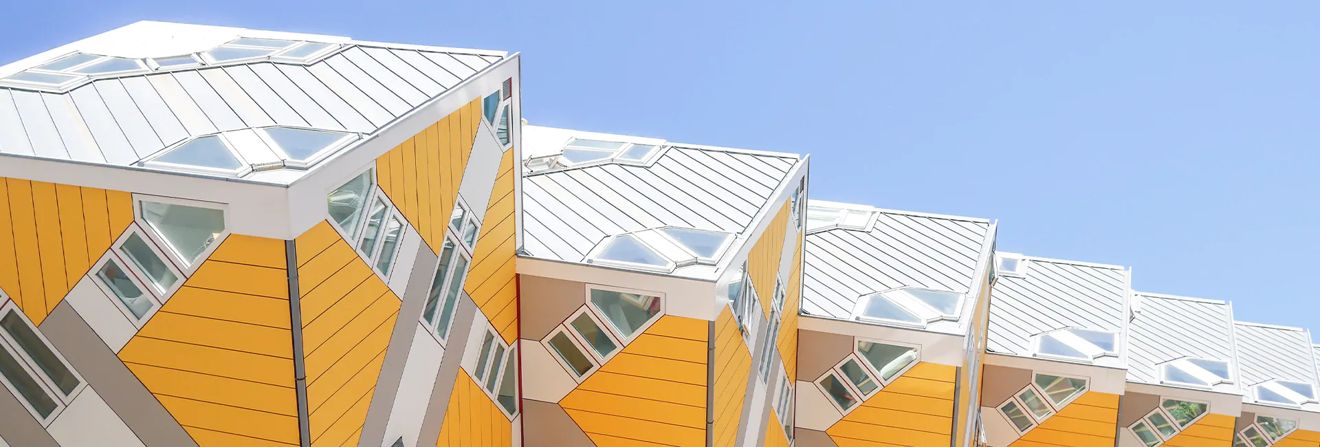 row-of-yellow-and-white-buildings-with-a-blue-sky