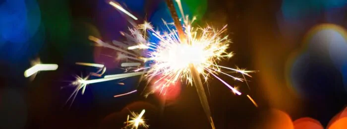 Hand Holding a Burning Sparkler Firework, Happy New Year and Merry Christmas Concept