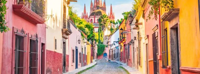 Vibrant, colorful buildings line a street in Mexico